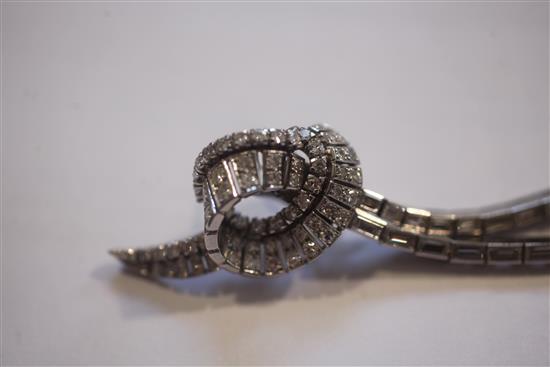A nice pair of platinum and diamond encrusted scrolling and double drop earrings, 6.5cm.